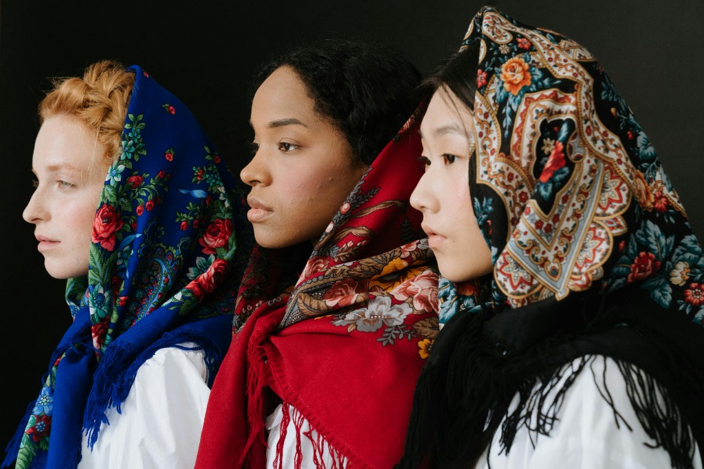 Lifestyle — three models in profile, patterned scarves