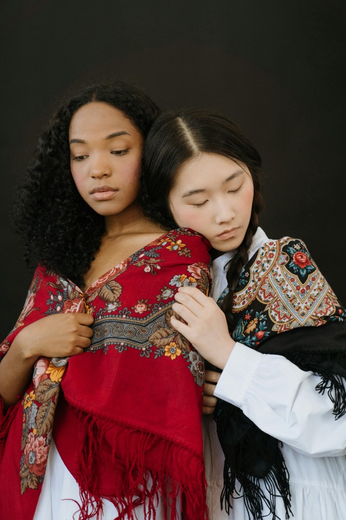 Lifestyle — two models in embroidered shawls, intimate portrait